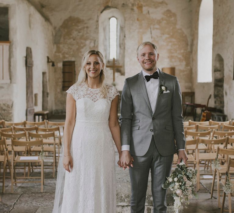 Bride in By Malina Bridal Gown & Groom in Grey Tiger of Sweden Suit