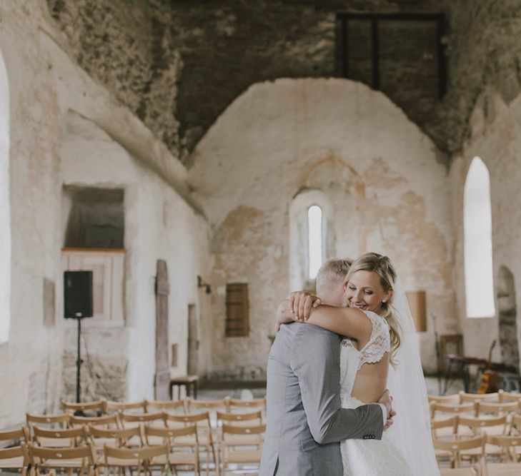 Bride in By Malina Bridal Gown & Groom in Grey Tiger of Sweden Suit