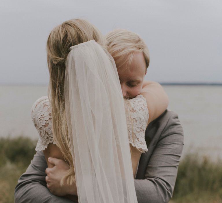 Bride in By Malina Bridal Gown & Groom in Grey Tiger of Sweden Suit