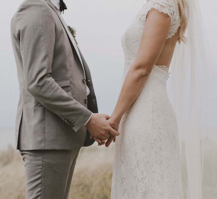 Bride in By Malina Bridal Gown & Groom in Grey Tiger of Sweden Suit