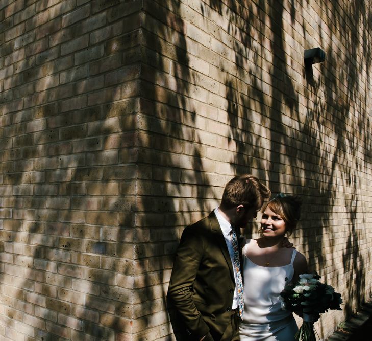 Delphine Manivet Bride With Bridesmaids In Reformation & Stylish London Wedding At Town Hall Hotel With Groom In Light Green & Images By Chris Barber