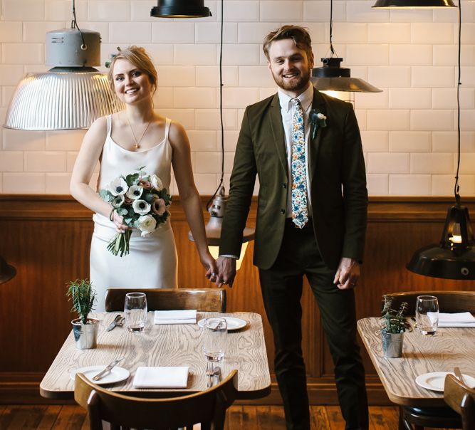 Delphine Manivet Bride With Bridesmaids In Reformation & Stylish London Wedding At Town Hall Hotel With Groom In Light Green & Images By Chris Barber