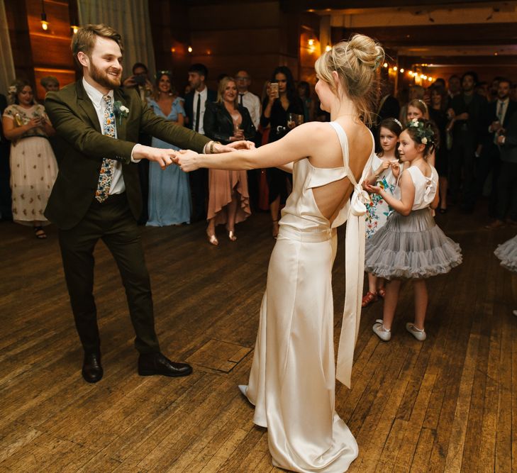 Delphine Manivet Bride With Bridesmaids In Reformation & Stylish London Wedding At Town Hall Hotel With Groom In Light Green & Images By Chris Barber