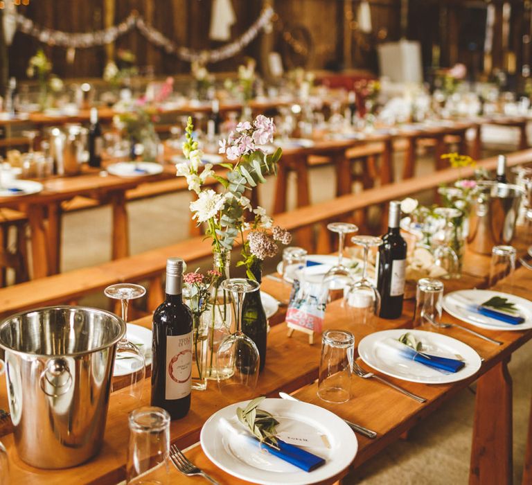 Wooden Trestle Tables With Bud Vases And White Drapes // Daisy By Halfpenny London For A Boho Barn Wedding In Yorkshire With Decor By Wild At Heart Weddings Images By Photography 34