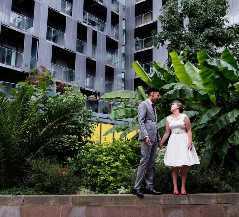 Bride in Bespoke Tea Length Wedding Dress | Groom in Grey Jaeger Suit | 60s Inspired London Pub Wedding | The Peasant | Babb Photo