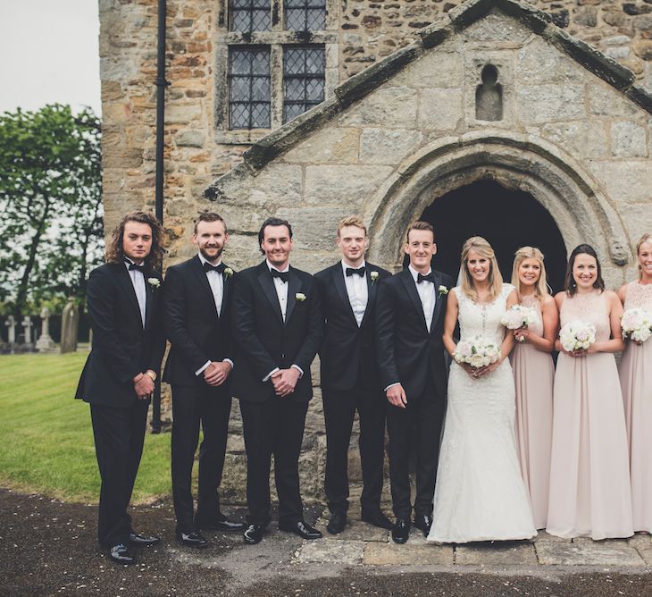 Groomsmen in Black Tie, Bride in Lace & Bridesmaid in Pink Dessy Dresses