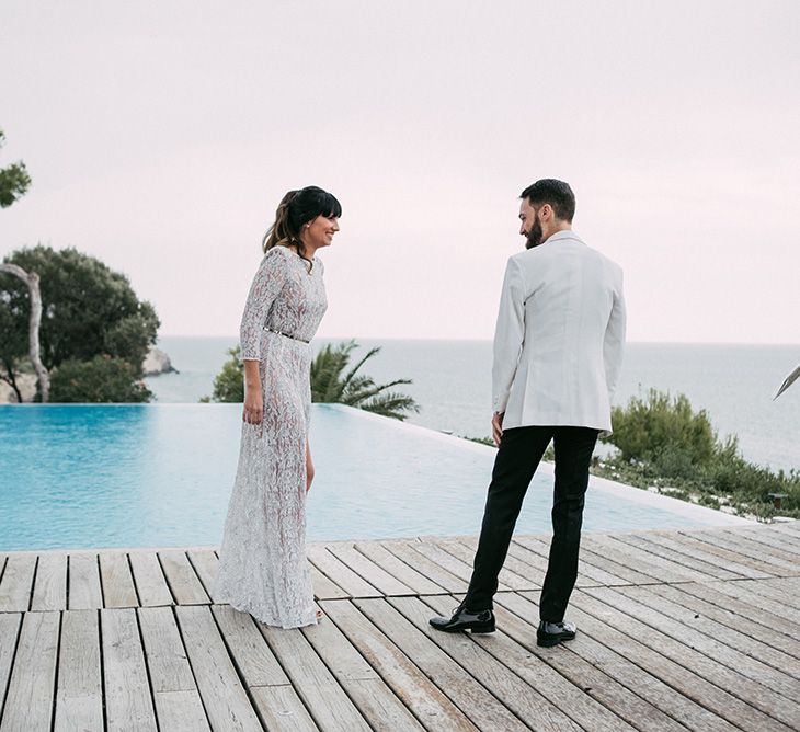 First Look | Groom in Tailor Made Tom Black Suit | Bride in Embellished Ze García Bridal Gown with Front Split | Stylish Outdoor Wedding at Masia Casa del Mar in Barcelona, Spain | Sara Lobla Photography | Made in Video Film