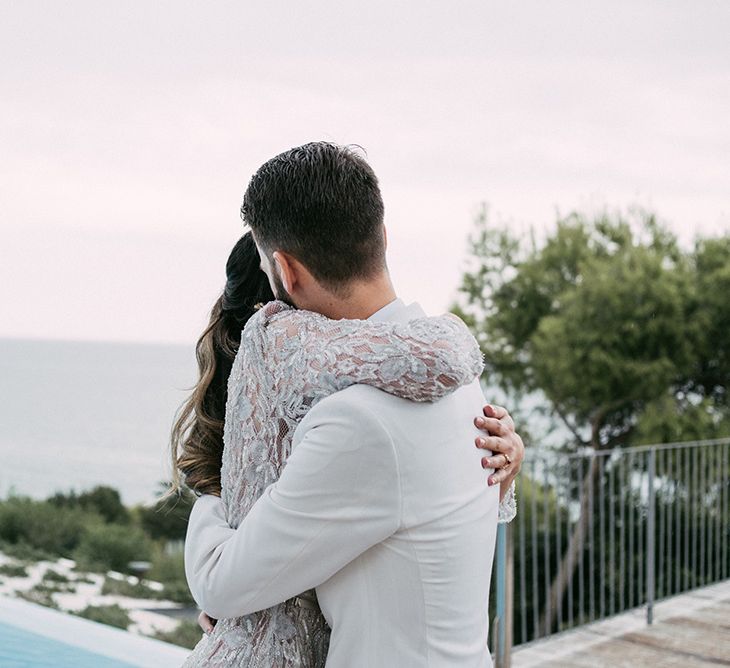 First Look | Groom in Tailor Made Tom Black Suit | Bride in Embellished Ze García Bridal Gown with Front Split | Stylish Outdoor Wedding at Masia Casa del Mar in Barcelona, Spain | Sara Lobla Photography | Made in Video Film