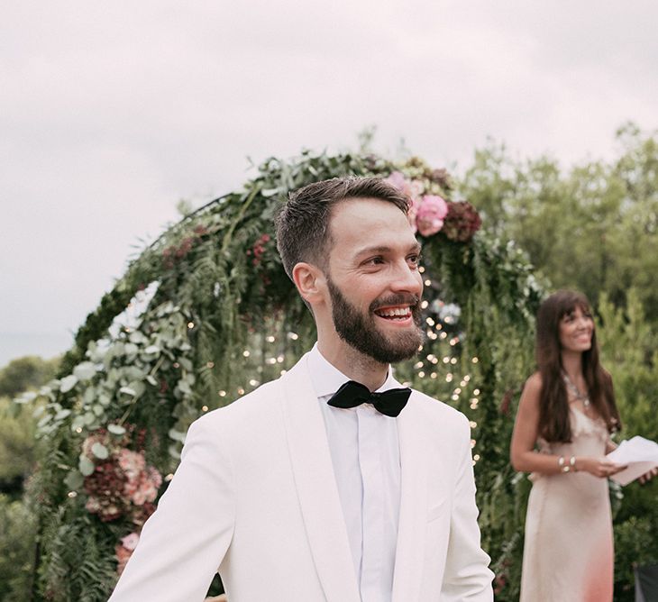 Wedding Ceremony | Groom at the Altar in Tailor Made Tom Black Suit | Stylish Outdoor Wedding at Masia Casa del Mar in Barcelona, Spain | Sara Lobla Photography | Made in Video Film