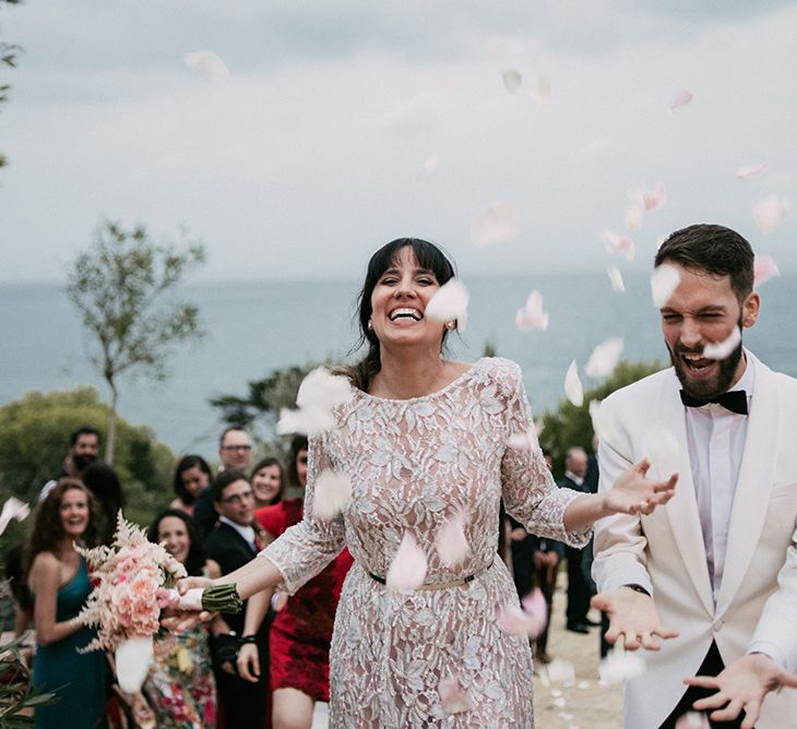 Confetti Exit | Bride in Embellished Ze García Bridal Gown with Front Split | Groom in Tailor Made Tom Black Suit | Stylish Outdoor Wedding at Masia Casa del Mar in Barcelona, Spain | Sara Lobla Photography | Made in Video Film