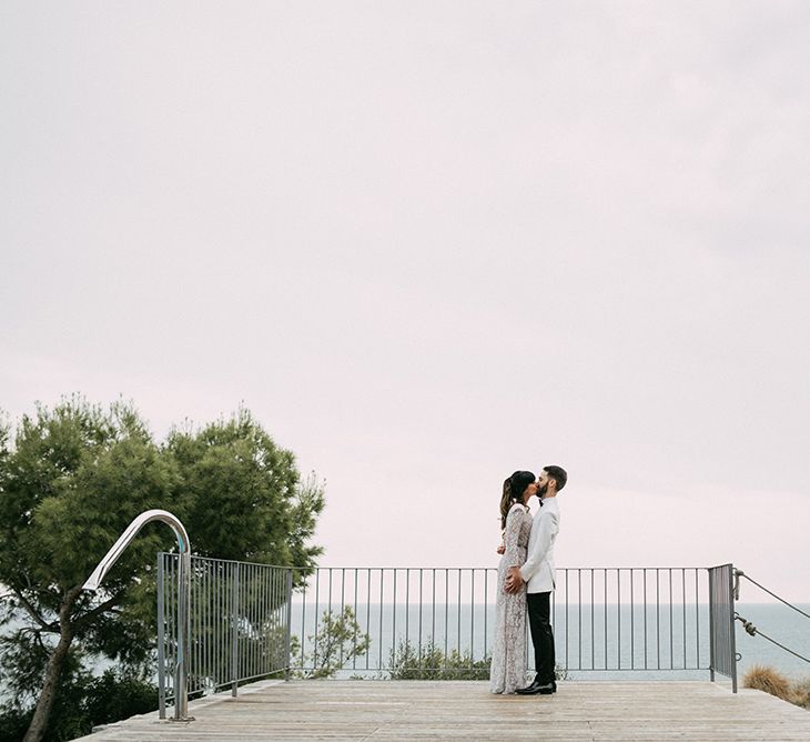 Bride in Embellished Ze García Bridal Gown with Front Split | Groom in Tailor Made Tom Black Suit | Stylish Outdoor Wedding at Masia Casa del Mar in Barcelona, Spain | Sara Lobla Photography | Made in Video Film