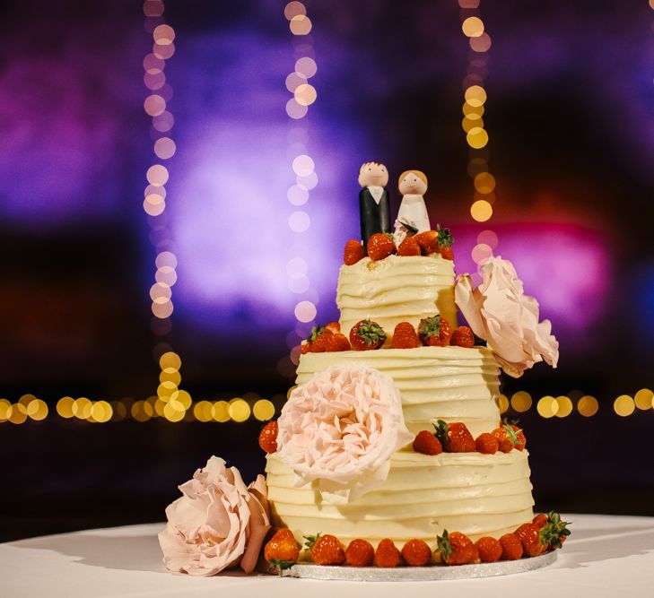 Frosting Wedding Cake with Fruit Decor