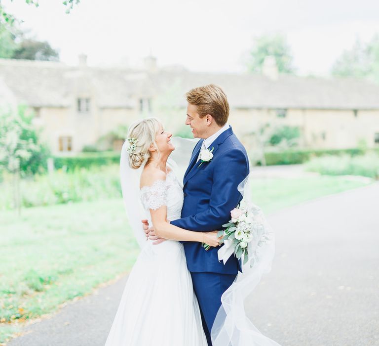 Bride in Naomi Neoh Loretta Gown with Stewart Parvin Lace Jacket & Suzanne Neville Belt | Groom in Navy Ted Baker Suit