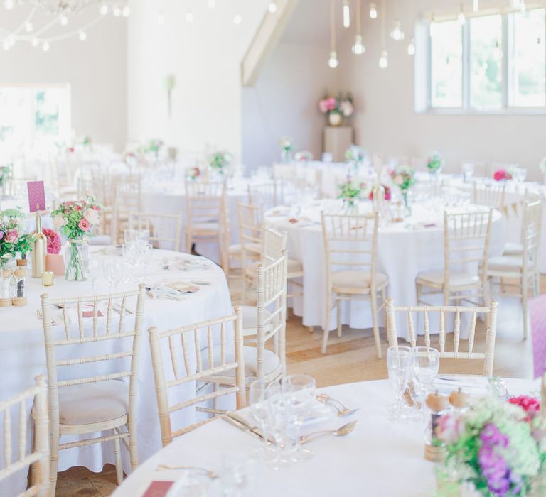 Barn Reception with Pink Flowers & Hanging Lights