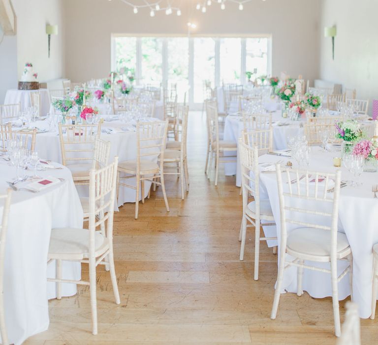 Barn Reception with Pink Flowers & Hanging Lights