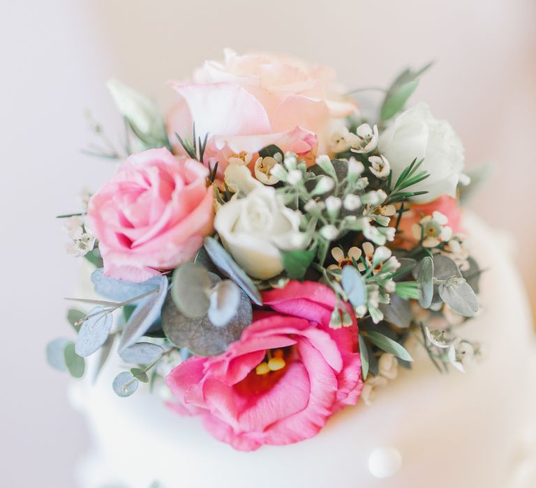 Traditional White Wedding Cake with Pink Flowers on a Tree Stump Cake Stand