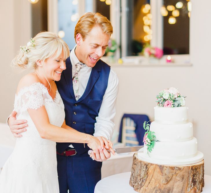 Bride & Groom Cutting The Cake