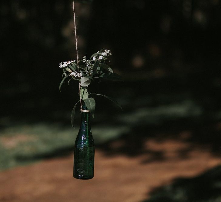 Bottles Of Flowers Hanging From Tree