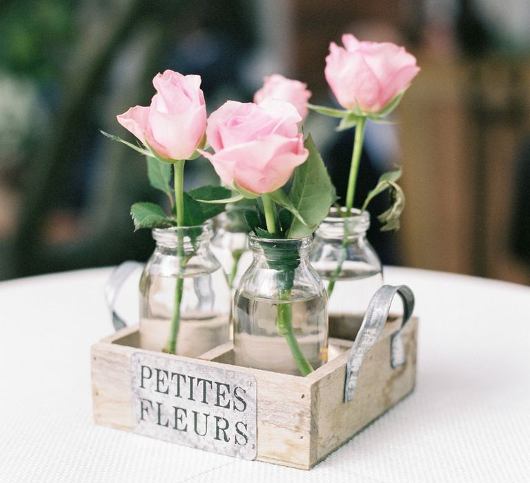 Milk Bottles filled with Pink Flower Stems