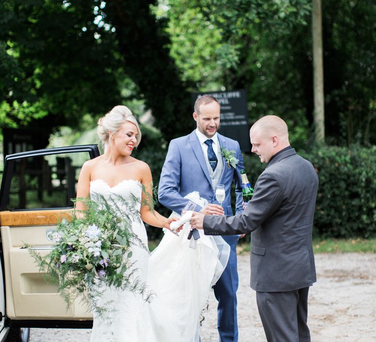 Bride with Foliage Filled Bouquet by Frog Manchester