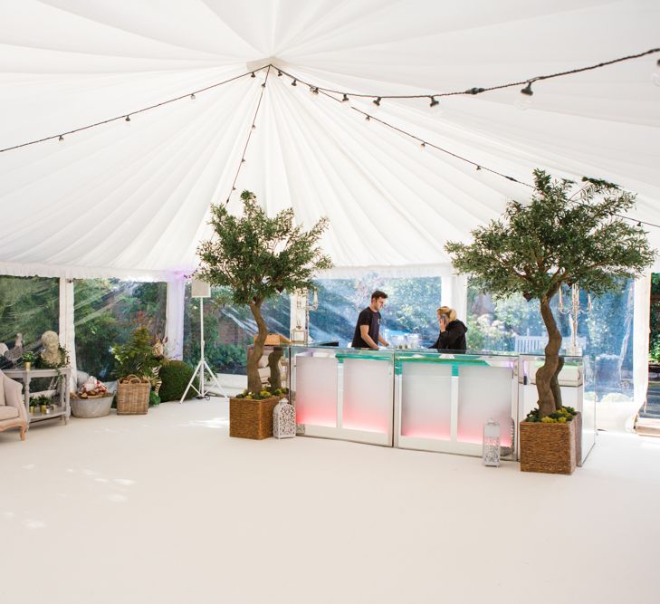 Botanical Marquee Reception with Hanging Greenery & Edison Light Installations | Lucy Davenport Photography