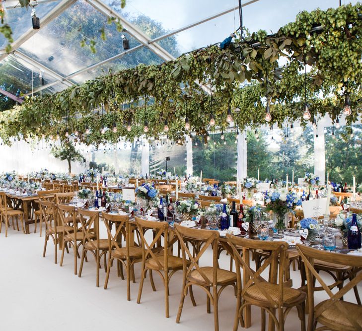 Botanical Marquee Reception with Hanging Greenery & Edison Light Installations | Lucy Davenport Photography