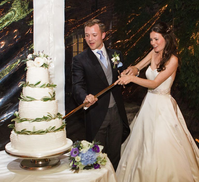 Cutting the Wedding Cake | Classic Bride in Caroline Castigliano Wedding Dress | Groom in Cad & the Dandy Tails | Lucy Davenport Photography