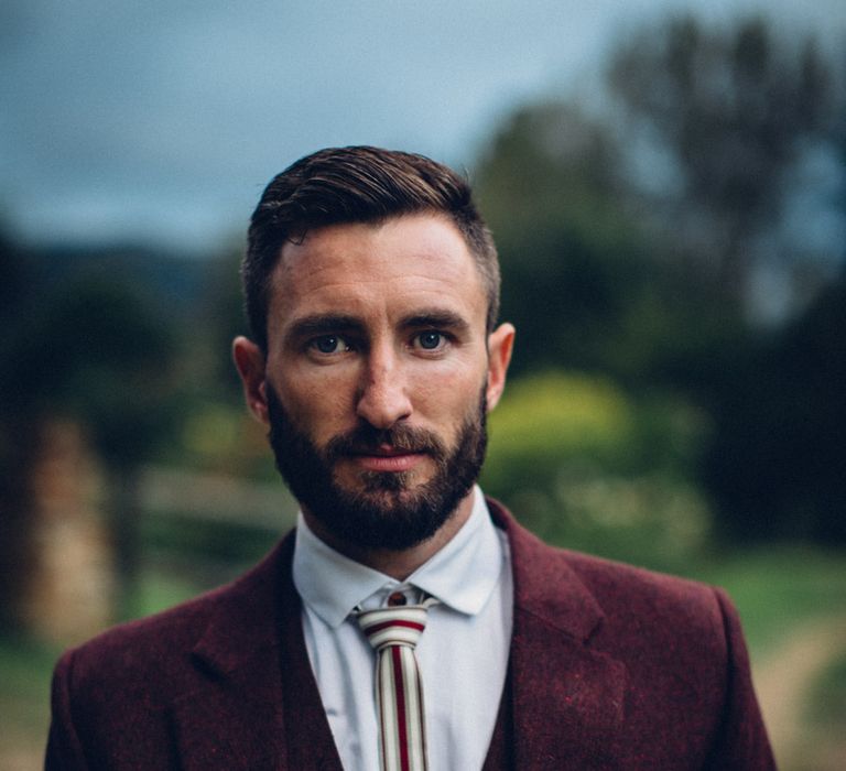 Groom in Bespoke Burgundy Suit by Terrence Bray | Steampunk Barn Wedding | | Andy & Szerdi Photography | Forman Wedding Films