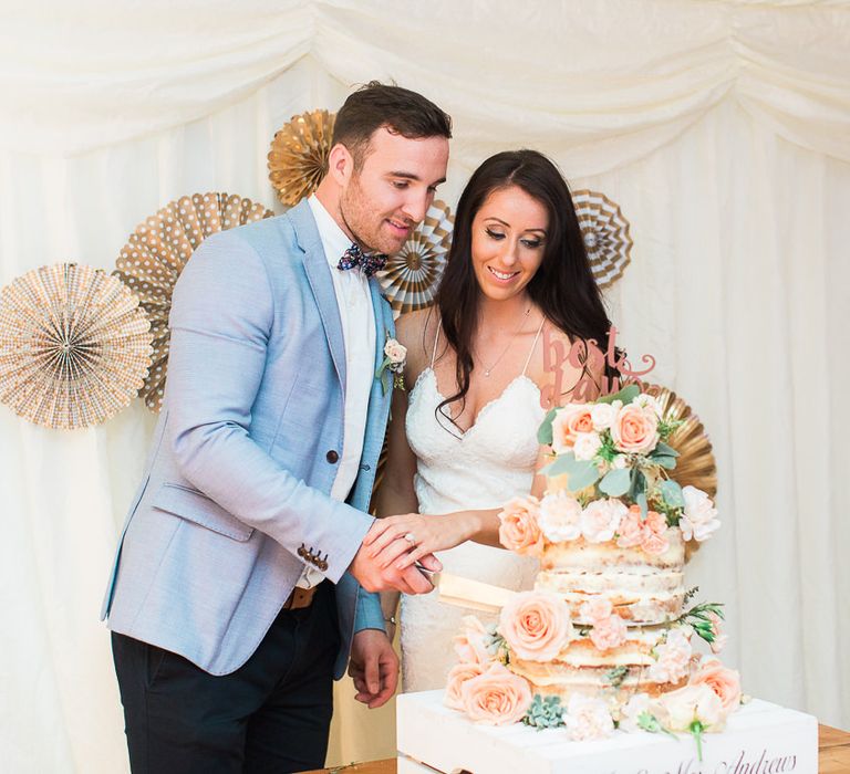 Cutting the Semi Naked Wedding Cake | Bride in Backless Katie May Gown | Groom in Zara Blazer & Topman Trousers | Sung Blue Photography | ROOST Film Co.