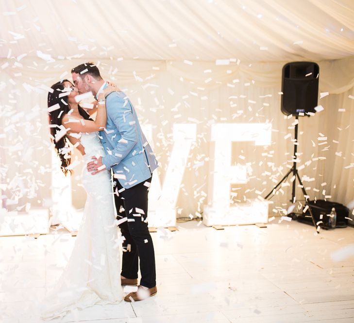 Confetti Dance Floor Moment | Giant LOVE Lights | Bride in Backless Katie May Gown | Groom in Zara Blazer & Topman Trousers | Sung Blue Photography | ROOST Film Co.