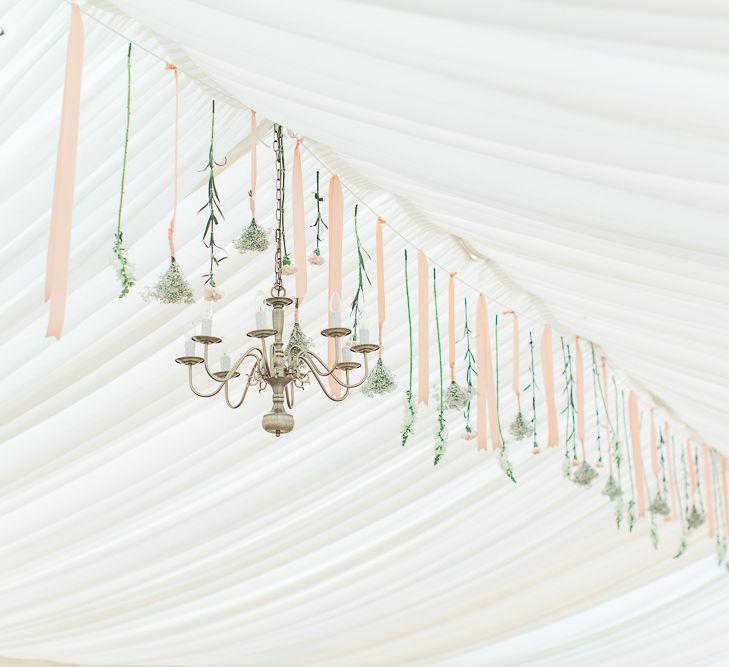 Chandelier & Hanging Floral Arrangement | Elegant Peach, Copper & Rose Gold At Home Marquee Reception | Sung Blue Photography | ROOST Film Co.