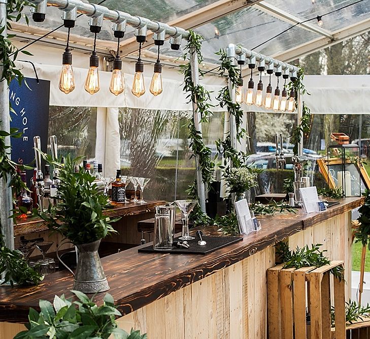 Wooden Bar With Edison Bulbs From <a href="https://www.thewateringholeeventbars.co.uk/" rel="noopener" target="_blank">The Watering Hole Event Bars</a>