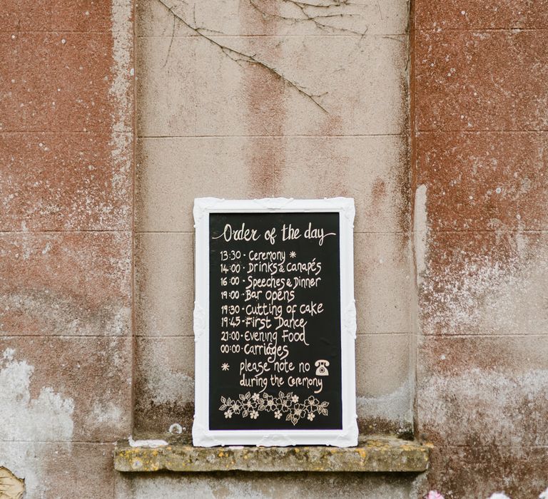 Chalkboard Order of the Day Sign | Outdoor Ceremony & Rustic Barn Reception at Pennard House Somerset | John Barwood Photography