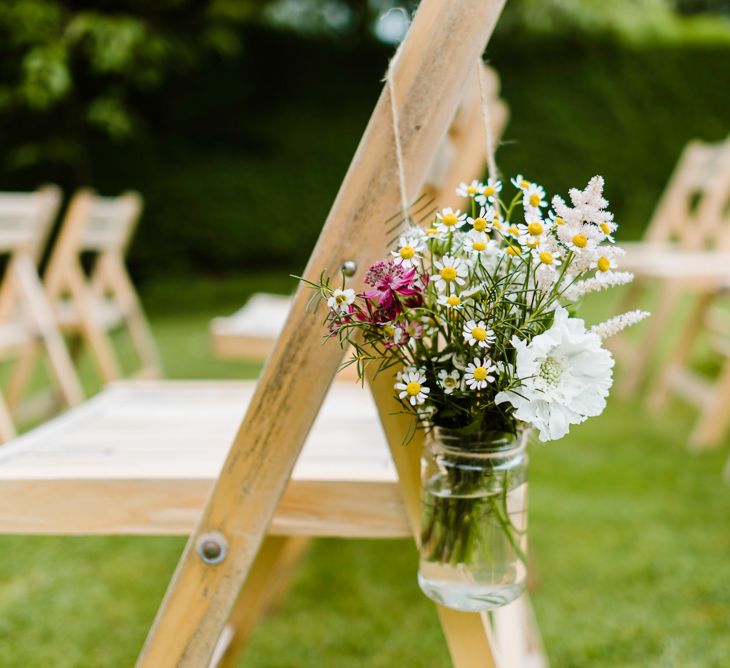 Aisle Chair Back Flowers | Outdoor Ceremony & Rustic Barn Reception at Pennard House Somerset | John Barwood Photography