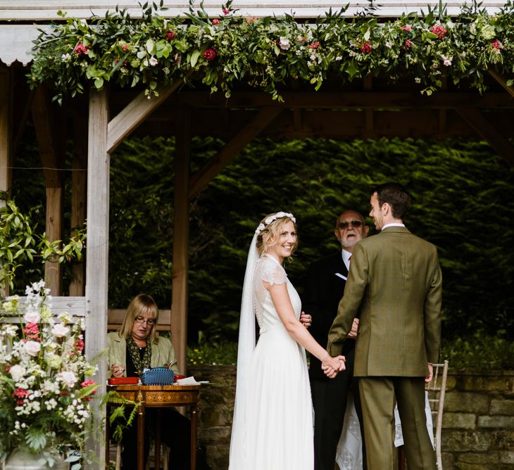 Wedding Ceremony | Bride in Jenny Packham Gown | Groom in Hugo Morris Tweed Suit | Outdoor Ceremony & Rustic Barn Reception at Pennard House Somerset | John Barwood Photography