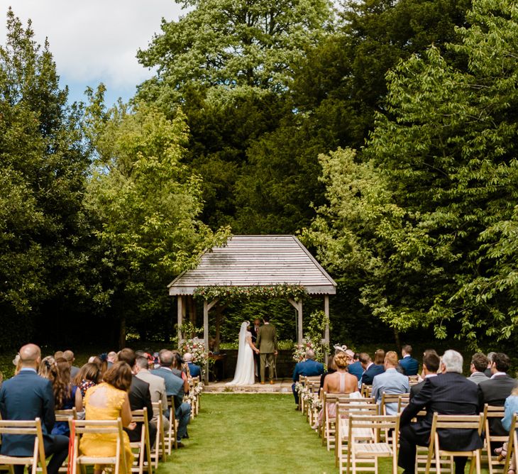 Wedding Ceremony | Bride in Jenny Packham Gown | Groom in Hugo Morris Tweed Suit | Outdoor Ceremony & Rustic Barn Reception at Pennard House Somerset | John Barwood Photography