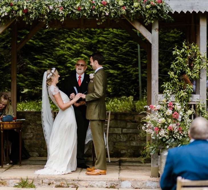 Wedding Ceremony | Bride in Jenny Packham Gown | Groom in Hugo Morris Tweed Suit | Outdoor Ceremony & Rustic Barn Reception at Pennard House Somerset | John Barwood Photography