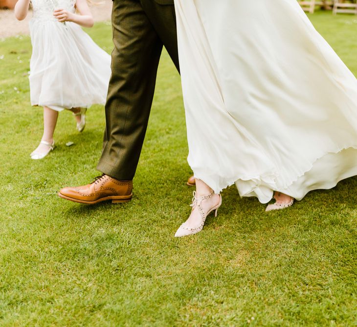 Wedding Ceremony | Aquazzura Bridal Shoes | Loake Brouque Grooms Shoes | Outdoor Ceremony & Rustic Barn Reception at Pennard House Somerset | John Barwood Photography