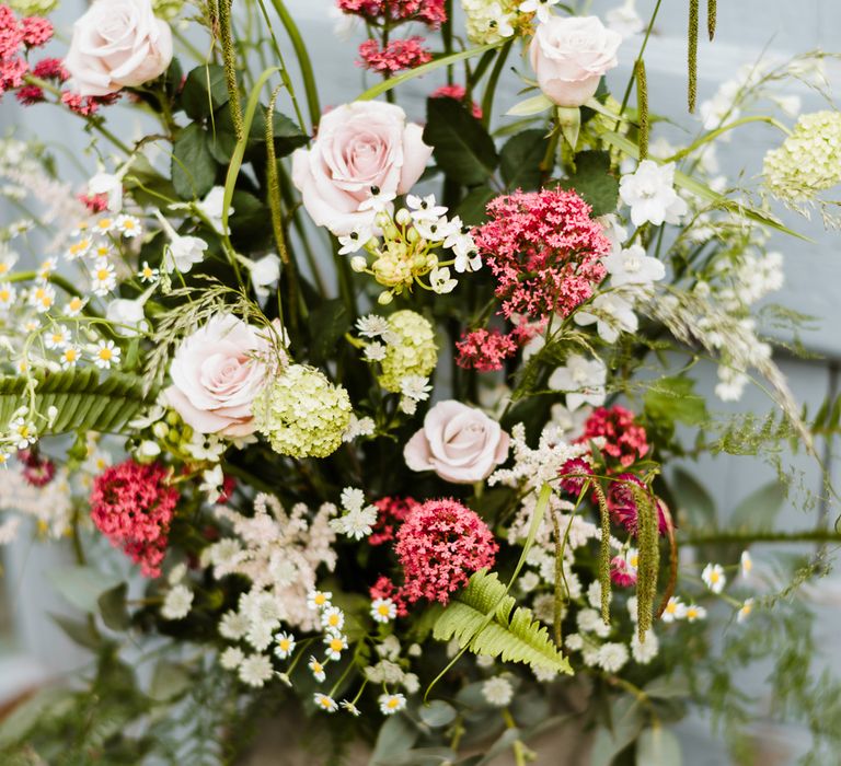 Milk Churn Floral Arrangement | Outdoor Ceremony & Rustic Barn Reception at Pennard House Somerset | John Barwood Photography