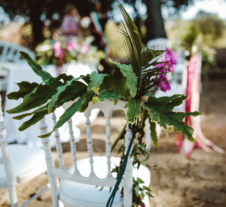 Chair Back Flowers | Tropical Green & Fuchsia Pink Outdoor Wedding at Castellina de Miremont, Italy Planned & Styled by Come le Ciliegie Wedding & Events | Images by Effeanfotografie | Film by Headshot Weddings