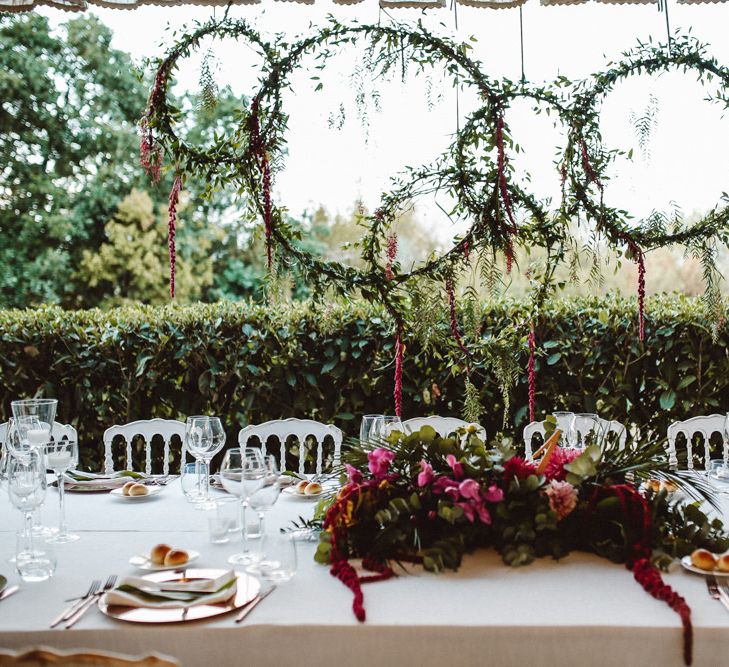 Greenery Hoops Top Table Backdrop | Tropical Green & Fuchsia Pink Outdoor Wedding at Castellina de Miremont, Italy Planned & Styled by Come le Ciliegie Wedding & Events | Images by Effeanfotografie | Film by Headshot Weddings