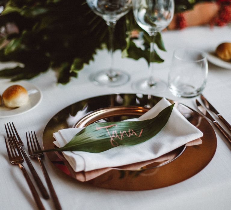 Place Setting with Gold Platter | Tropical Green & Fuchsia Pink Outdoor Wedding at Castellina de Miremont, Italy Planned & Styled by Come le Ciliegie Wedding & Events | Images by Effeanfotografie | Film by Headshot Weddings