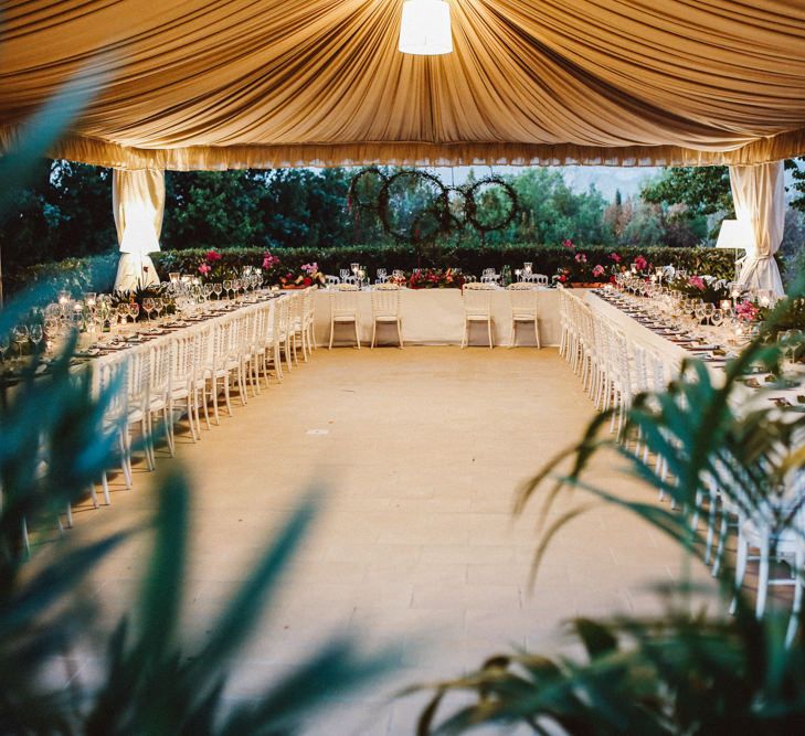 Reception Decor | Greenery Hoops Top Table Backdrop | Tropical Green & Fuchsia Pink Outdoor Wedding at Castellina de Miremont, Italy Planned & Styled by Come le Ciliegie Wedding & Events | Images by Effeanfotografie | Film by Headshot Weddings