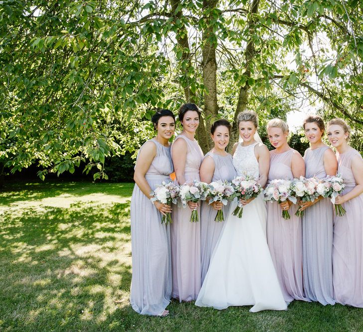 Bride In Sassi Holford With Bridesmaids In Purple & Pink Maxi Dresses From Debenhams