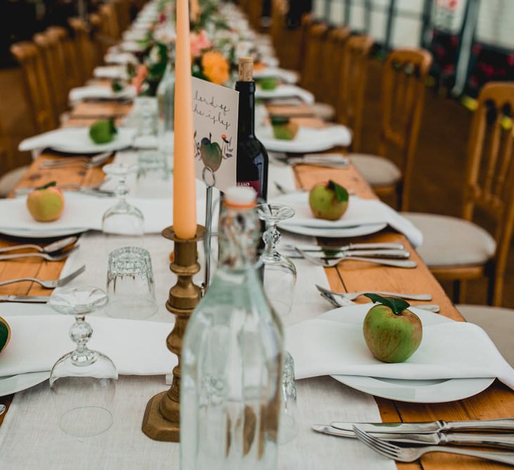 Rustic Wedding Decor For Wooden Trestle Tables / Floral Lined Marquee For Wedding // Embellished Jenny Packham Gown Marquee Wedding At Coombeshead Farm Cornwall The Garden Gate Flower Co Planning Jenny Wren Events Images Barney Walters Photography