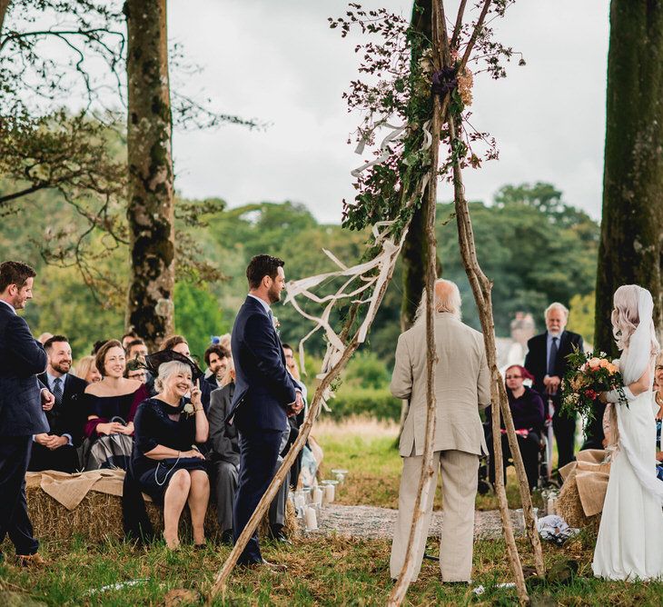 Tree Copse Wedding Ceremony With Hay Bale Seating // Farm Wedding Venue Cornwall // Embellished Jenny Packham Gown Marquee Wedding At Coombeshead Farm Cornwall The Garden Gate Flower Co Planning Jenny Wren Events Images Barney Walters Photography