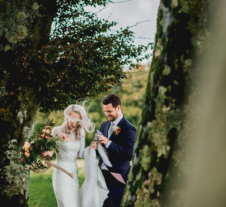 Tree Copse Wedding Ceremony With Hay Bale Seating // Farm Wedding Venue Cornwall // Embellished Jenny Packham Gown Marquee Wedding At Coombeshead Farm Cornwall The Garden Gate Flower Co Planning Jenny Wren Events Images Barney Walters Photography