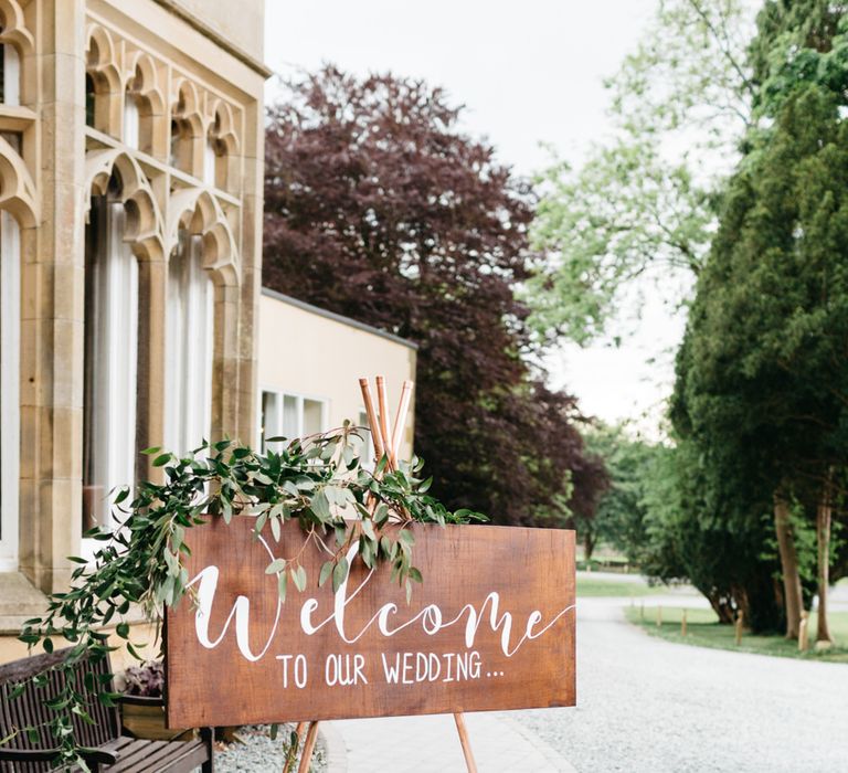 Wooden Welcome Sign with Greenery Garland | Greenery & White Marquee Wedding at The Villa, Levens with Copper Details | Bowtie and Belle Photography