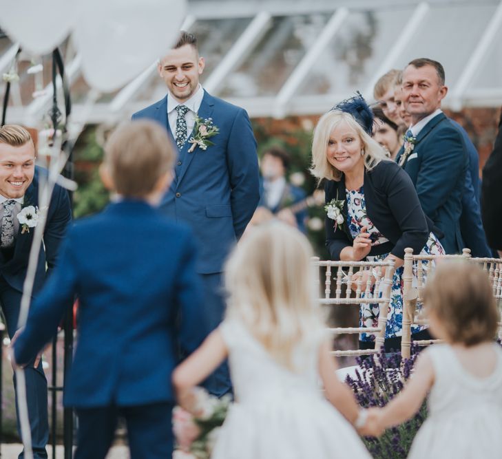 Groom Waiting At End Of Aisle