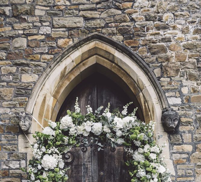 Floral Arch outside Church Entrance with Greenery and White Flowers including Hydrangeas